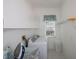 Laundry room with tile floors, full sized washer and dryer, and overhead storage at 470 Bermuda Isles Cir, Venice, FL 34292