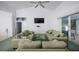 Cozy living room with a ceiling fan, open access to the kitchen, and natural light at 470 Bermuda Isles Cir, Venice, FL 34292