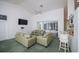 Bright living room with comfortable seating and access to an enclosed outdoor space at 470 Bermuda Isles Cir, Venice, FL 34292