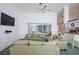 Inviting living room with comfortable seating, a ceiling fan, and an open layout to the kitchen at 470 Bermuda Isles Cir, Venice, FL 34292