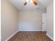 This bedroom features hardwood floors, a ceiling fan, fresh paint, and a window at 912 Magnolia Dr, Clearwater, FL 33756