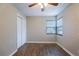 This bedroom features hardwood floors, a ceiling fan, a window, and a closet for ample storage space at 912 Magnolia Dr, Clearwater, FL 33756