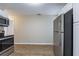 Open kitchen featuring stainless steel appliances and wood-look floors at 912 Magnolia Dr, Clearwater, FL 33756