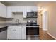 Bright kitchen featuring stainless steel appliances, white cabinets, and granite countertops at 912 Magnolia Dr, Clearwater, FL 33756