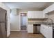Modern kitchen with stainless steel appliances, granite counters, and wood-look floors at 912 Magnolia Dr, Clearwater, FL 33756