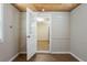 A bonus room with custom wood ceiling, fresh paint, and hardwood floors, and a view to the kitchen at 912 Magnolia Dr, Clearwater, FL 33756