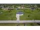 Aerial view of a modern single Gathering home with a long driveway and green lawn at 193 Rotonda S Blvd, Rotonda West, FL 33947