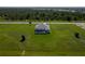 Aerial view of a modern home with a large lawn and screened pool at 193 Rotonda S Blvd, Rotonda West, FL 33947