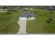 Aerial view of this new construction home with a three car garage, paver driveway and modern design at 193 Rotonda S Blvd, Rotonda West, FL 33947