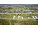 Expansive aerial view showcasing a residential community with canals, ponds and houses, creating a serene landscape at 209 Rotonda S Blvd, Rotonda West, FL 33947