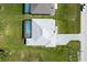 A top-down view of a single-Gathering home with a screened-in pool and paved driveway at 209 Rotonda S Blvd, Rotonda West, FL 33947