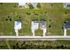 Aerial view of three modern homes each featuring a private pool, driveway, and contemporary architectural design at 209 Rotonda S Blvd, Rotonda West, FL 33947