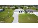 A full view of a single-story home and neighboring houses in a landscaped neighborhood at 209 Rotonda S Blvd, Rotonda West, FL 33947