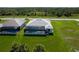 An aerial view of a home with a screened-in pool and a well-manicured lawn in a desirable neighborhood at 209 Rotonda S Blvd, Rotonda West, FL 33947