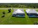 Aerial view of a single Gathering home with a screened-in pool and a lush, green backyard at 211 Rotonda S Blvd, Rotonda West, FL 33947