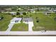 Aerial view of two single Gathering homes with well-maintained lawns in a neatly arranged neighborhood at 211 Rotonda S Blvd, Rotonda West, FL 33947