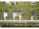 Top-down aerial view of a neatly arranged residential street with well-maintained properties and green lawns at 211 Rotonda S Blvd, Rotonda West, FL 33947