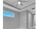 Bedroom with a tray ceiling and a window that brings in natural light at 211 Rotonda S Blvd, Rotonda West, FL 33947
