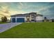 Beautiful single-story home featuring a spacious lawn and a two-car garage at 211 Rotonda S Blvd, Rotonda West, FL 33947