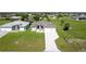 Well-maintained single Gathering home with a three-car garage, front lawn, and neatly paved driveway at 211 Rotonda S Blvd, Rotonda West, FL 33947