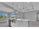 Spacious kitchen island with stainless steel sink and modern white cabinets at 211 Rotonda S Blvd, Rotonda West, FL 33947