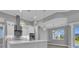 Modern kitchen featuring stylish backsplash, stainless-steel appliances, and quartz countertops at 211 Rotonda S Blvd, Rotonda West, FL 33947