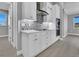 Well-organized kitchen with white cabinets, built-in oven, and decorative tile backsplash at 211 Rotonda S Blvd, Rotonda West, FL 33947