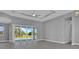 Bright living room with sliding glass doors that open up to a beautiful pool and backyard at 211 Rotonda S Blvd, Rotonda West, FL 33947