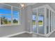 Bright windows showcase the outdoor view in this living area filled with natural light and blue skies at 211 Rotonda S Blvd, Rotonda West, FL 33947