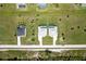 Aerial perspective of neighborhood with multiple homes and private pools, divided by a road and lush greenery at 221 Rotonda S Blvd, Rotonda West, FL 33947