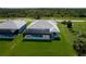Aerial view of a home showcasing a screened-in pool and a lush green lawn in a tranquil, scenic location at 221 Rotonda S Blvd, Rotonda West, FL 33947