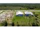 Aerial shot of two homes with screened-in pools and spacious backyards bordered by lush vegetation at 235 Rotonda S Blvd, Rotonda West, FL 33947
