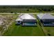 Aerial view of a backyard featuring a screened-in pool and well-maintained lawn on a sunny day at 235 Rotonda S Blvd, Rotonda West, FL 33947