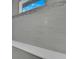 Detailed view of a shower showcasing sleek gray tiles, mosaic accents, and a built-in shelf at 235 Rotonda S Blvd, Rotonda West, FL 33947