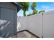 Backyard patio area with white vinyl fence, shed, and some greenery at 5112 Temple Heights Rd # B, Tampa, FL 33617