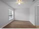 Bright bedroom featuring wood-look laminate flooring and a ceiling fan at 5112 Temple Heights Rd # B, Tampa, FL 33617