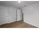 Bedroom with wood-look laminate flooring, two closets, and ensuite bathroom access at 5112 Temple Heights Rd # B, Tampa, FL 33617