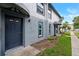 Exterior view of the townhome entrance featuring a blue front door and matching brick facade at 5112 Temple Heights Rd # B, Tampa, FL 33617