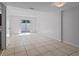 Open concept living area with tile flooring and sliding glass doors leading to the outside at 5112 Temple Heights Rd # B, Tampa, FL 33617