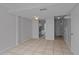 Open-concept living room features tile flooring and access to the kitchen and entrance at 5112 Temple Heights Rd # B, Tampa, FL 33617