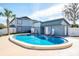 Community pool featuring a clear blue pool, nearby lounge chairs, and a pool house building at 5112 Temple Heights Rd # B, Tampa, FL 33617