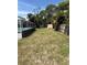 Large backyard featuring a shed, mature trees, and a screened in pool at 431 David Ct, Palm Harbor, FL 34684