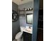 Functional half bathroom with a modern vanity, a decorative mirror, and tasteful decor at 431 David Ct, Palm Harbor, FL 34684