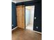 Bathroom doorway featuring wooden sliding door and tiled flooring at 431 David Ct, Palm Harbor, FL 34684