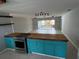 Open-concept kitchen with a wooden island, stainless steel appliances, and ample counter space, perfect for modern living at 431 David Ct, Palm Harbor, FL 34684