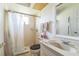Bathroom featuring a shower, a window, toilet and single sink vanity at 26098 Copiapo Cir, Punta Gorda, FL 33983