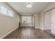 Finished basement featuring wood-look flooring, windows, and a door to another room at 4906 S 87Th St, Tampa, FL 33619