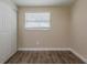 Bedroom featuring wood-look floors and closet with ample natural light at 4906 S 87Th St, Tampa, FL 33619