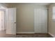 Bedroom with closet, wood-look flooring, and a door leading to another room at 4906 S 87Th St, Tampa, FL 33619