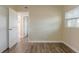 Bedroom with wood-look flooring, closet, and a view into the ensuite bathroom at 4906 S 87Th St, Tampa, FL 33619